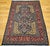 "This vintage Persian Tabriz rug from the early 20th century showcases an exquisite allover floral pattern on a deep navy...