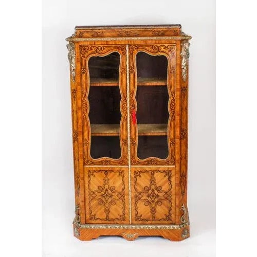 This is a handsome Antique ormolu mounted wood and Gonçalo Alves marquetry vitrine in the Louis XV transitional style,...