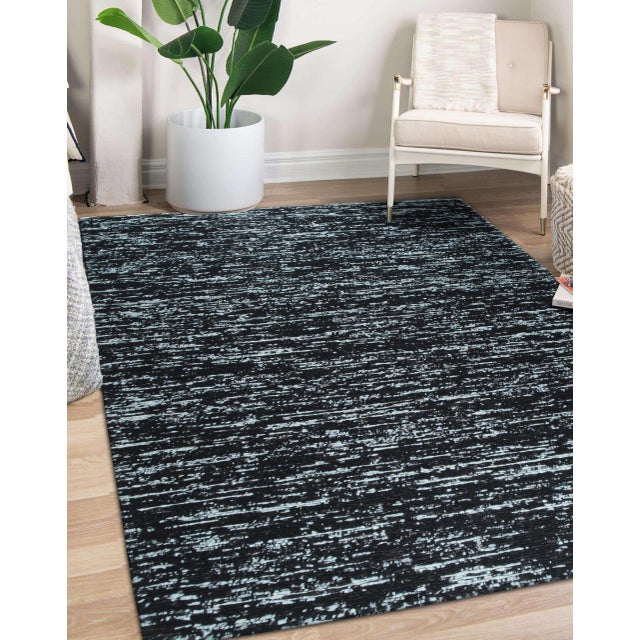 Fiona Rustic Black Flatweave Wool Rug, Country of Origin: India. This contemporary flatweave piece reinterprets...