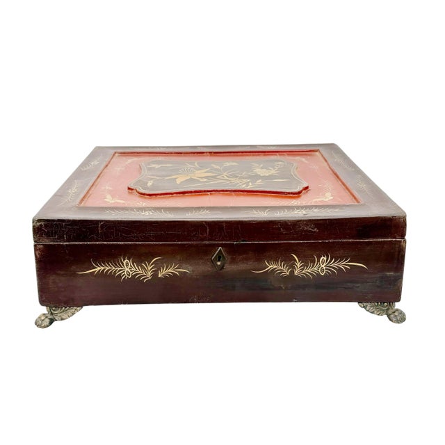 A finely detailed Chinese export lacquered work box, dating to the early 19th century. This rectangular example features a...