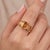 Embrace warm, radiant sunshine with this striking three-stone ring, featuring a trio of golden-yellow emerald-cut stones...