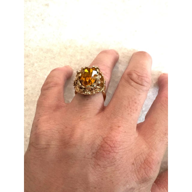 Wonderful Brutalist style cocktail ring with oval cut glass in a gold-tone chunky setting.
