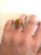 Wonderful Brutalist style cocktail ring with oval cut glass in a gold-tone chunky setting.