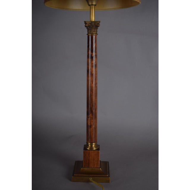 This elegant mid-century table lamp combines warm, richly figured wood with refined brass accents for a timeless,...