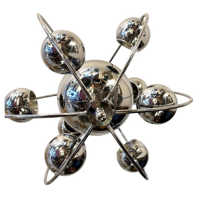 Italian mid-century space-age chandelier by reggiani from 1960-70s. the chandelier is made in chrome metal. bulb holders:...