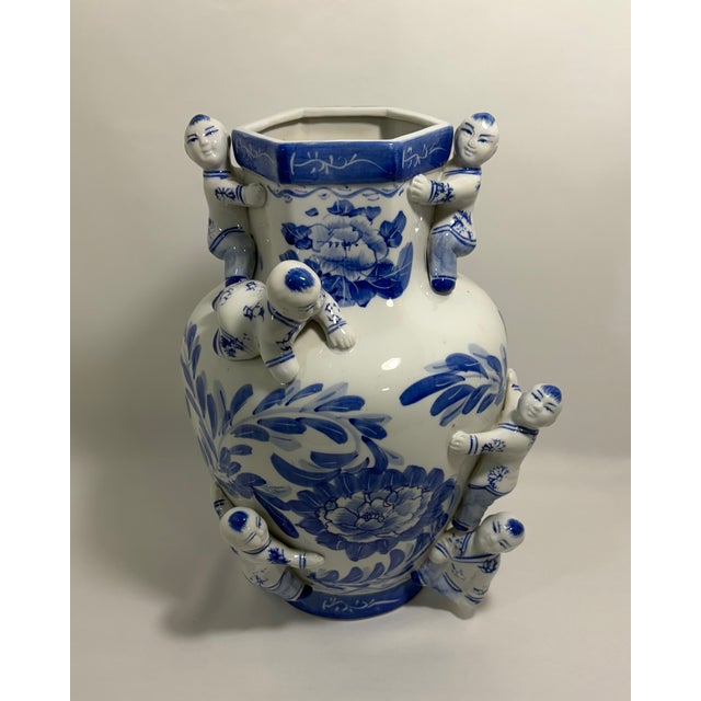Vintage Chinese blue-and-white porcelain Fertility Boys vase featuring sculptural applied figures of boys climbing around...