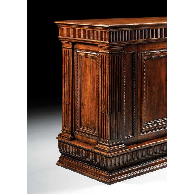 Handcrafted in Italy from solid walnut, this sideboard features a substantial design highlighted by fluted columns, carved...