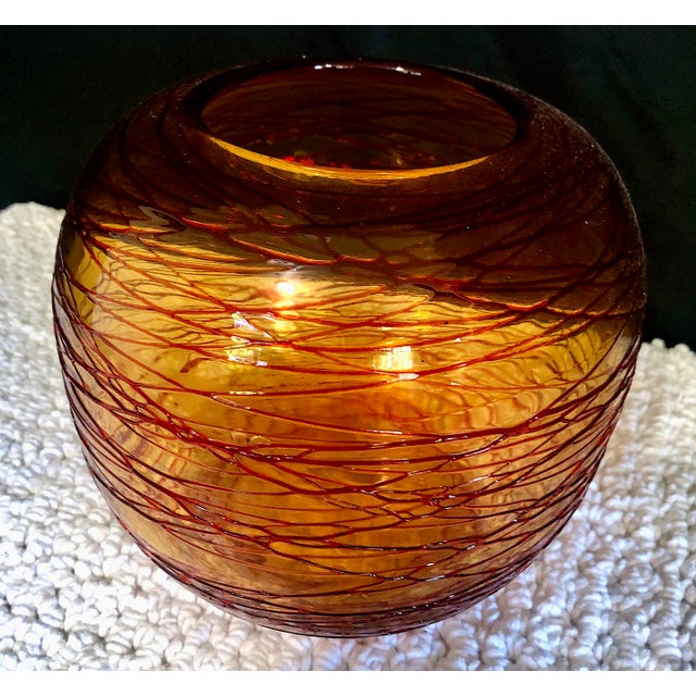 On offer is a stunning example of vintage hand-blown studio art glass, most notably featuring a distinctive "threaded" or...