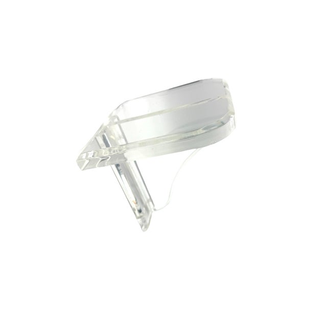 A substantial vintage clear Lucite wall display shelf distinguished by its thick beveled construction and elegant...