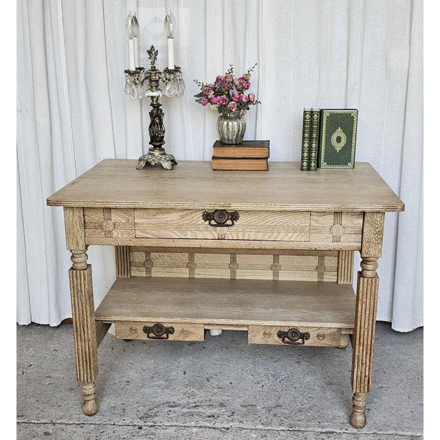 This early 19th-century American Arts & Crafts library table features quartersawn oak construction and intricate carved...