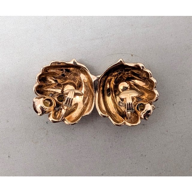 1950s goldtone shell shaped with two graduated oval faux-topaz clip earrings. Marked "Castlecliff" inside the backs of the...