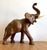 Elephant produced in the 1960s/1970s in brown leather with details of leather folds and glass eyes with slight signs of...