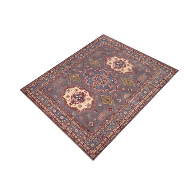 "Enhance your home with this exquisite hand-knotted Kazak rug, crafted from fine hand-spun wool and dyed with all-natural...