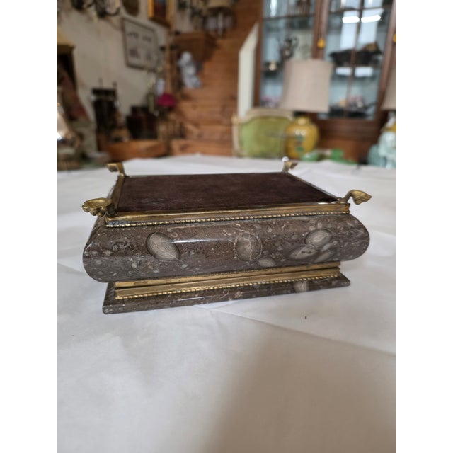 Great looking solid stone box with brass mounts and paw feet.