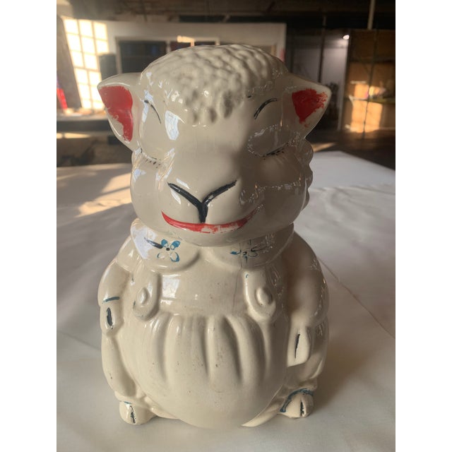 Vintage ceramic lamb character cookie jar. Mid 20th century with worn painted glaze on cream base.