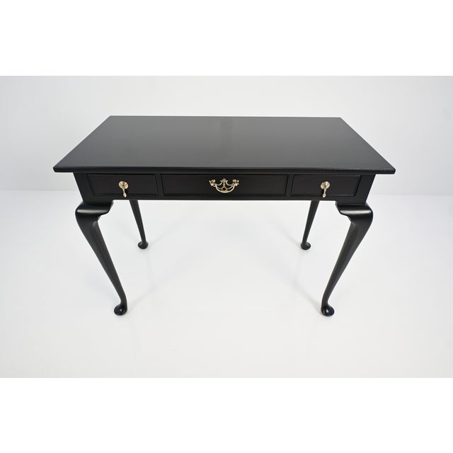 An exceptional finely crafted Kittinger writing desk or console table, newly refinished in a rich ebonized mahogany,...