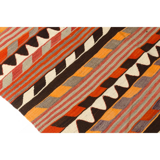 This is a vintage Turkish Oushak rug from the Mid 20th Century. The piece was hand-knotted.
