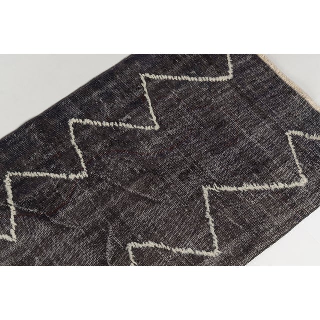 This is a vintage Turkish Oushak rug from the Mid 20th Century. The piece was hand-knotted.