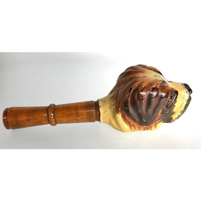 A continental antique hand carved hardwood nutcracker depictiting a St Bernard dog, embellished with hand painted detail...