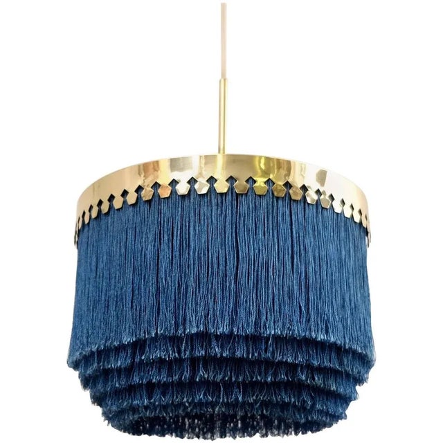 Blue fringes and brass. Produced by Hans-Agne Jakobsson, Markaryd, Sweden, 1960s. Height is adjustable. This piece is...