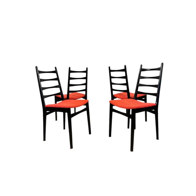 A striking set of four Italian dining chairs with classic mid-century modern charm. These sculptural ladder-back chairs...