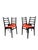 A striking set of four Italian dining chairs with classic mid-century modern charm. These sculptural ladder-back chairs...