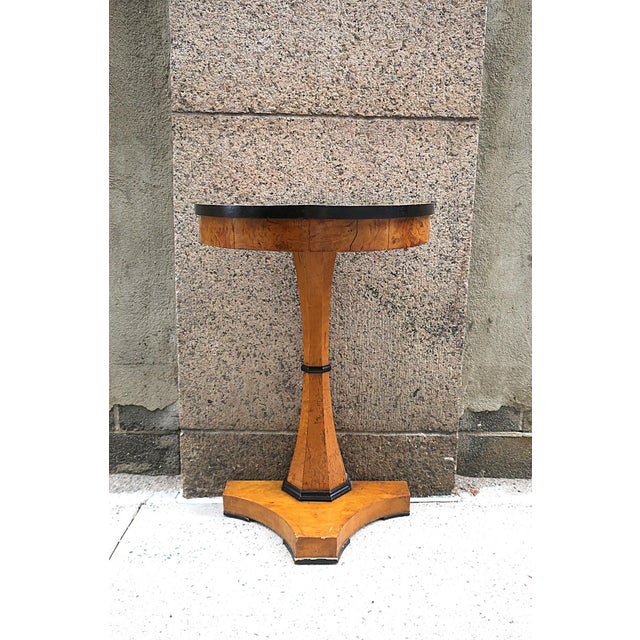 A German Biedermeier cherry wood demilune console cable, circa early-19th century, Germany. Console has a demilune (half-...