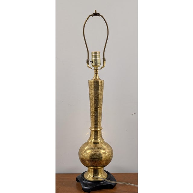 his striking mid-to-late 20th-century Asian brass table lamp injects a sense of vintage luxury and global character into...