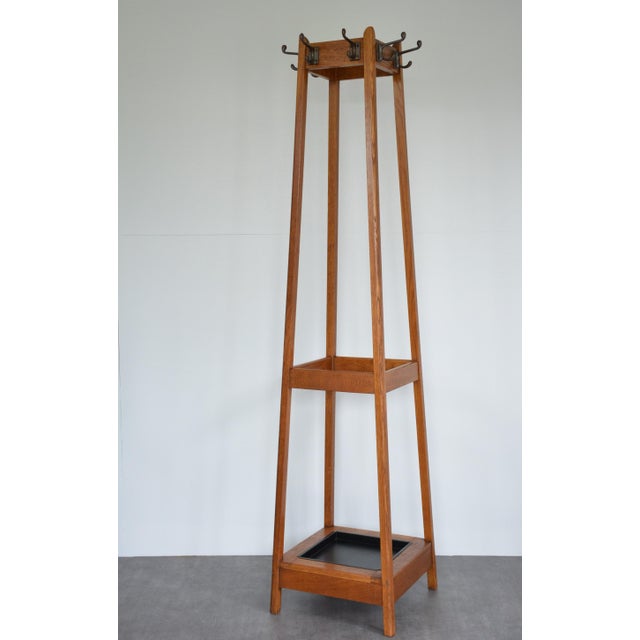 This exceptional mid-century oak hall stand seamlessly balances high-capacity utility with a clean, structural aesthetic....
