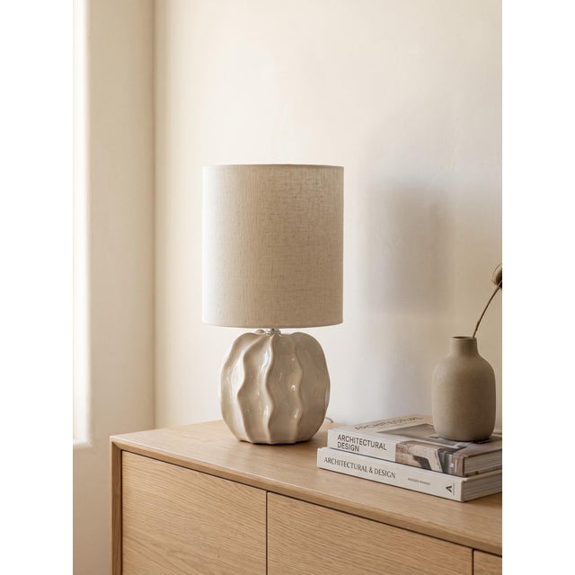 ⁠Charming contemporary accent table lamp featuring a sculptural, high-gloss white ceramic base with an elegant scalloped /...