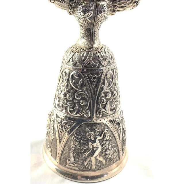 Exceptional pair of victorian silver wager cups. Each of typical design in form of a female in an upright position holding...