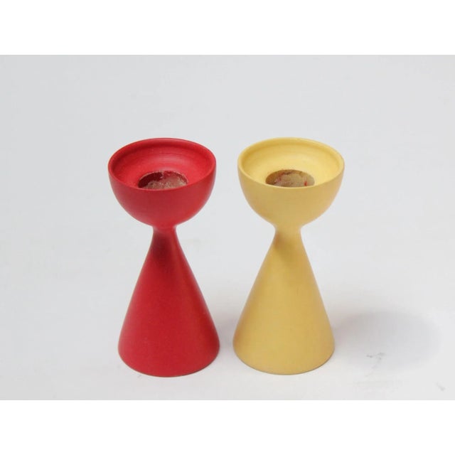 Small Danish Modern Candlesticks, one in yellow, one in red, with deeply sculpted forms. Paint shows some scuffs in...