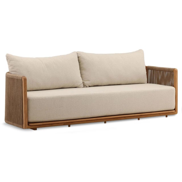 Outdoor teak wood frame sofa with brown twisted poly resin rope wrap. Cozy sand colored upholstered cushions. Each may...