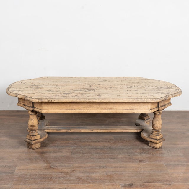 20th century French coffee table crafted in oak and finished with a bleached surface that reveals both lighter and darker...