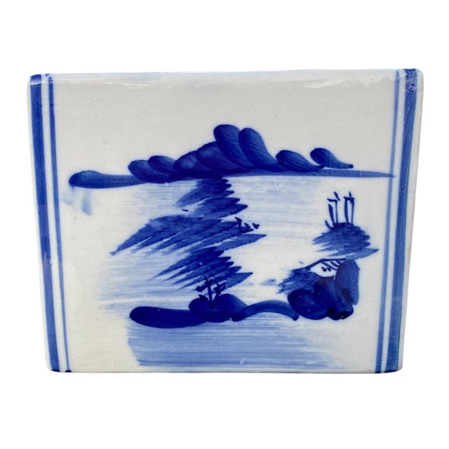 A beautiful porcelain opium pillow featuring classic blue-and-white decoration with hand-painted landscape motifs. The...