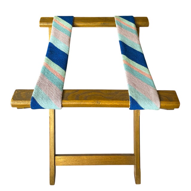 Charming, perky and preppy wooden luggage rack with pink, baby blue and navy blue needle point straps. Useful and...