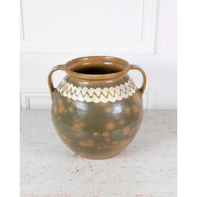 Made in Spain in the twentieth century, this glazed pot is a decorative earthenware vessel in the Spanish tradition. The...