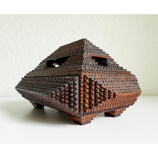 Exceptional tramp art box with dramatic pyramid shape atop four tapered feet. Handmade in the early 1900s using recycled...