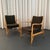 This pair of mid-century modern armchairs are modeled after the iconic model 45 chair by the Danish designer Finn Juhl....