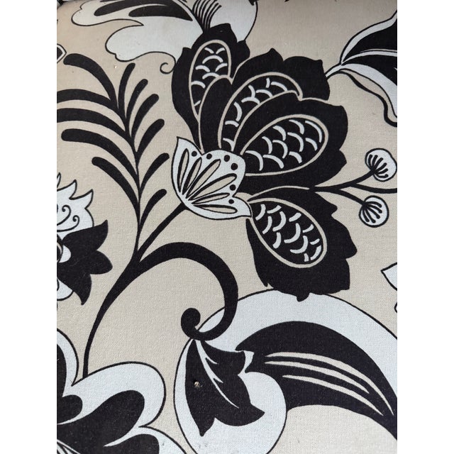 Fun swiveling barrel-back club chair upholstered in bold black-and-ivory floral fabric. It features a wraparound back,...