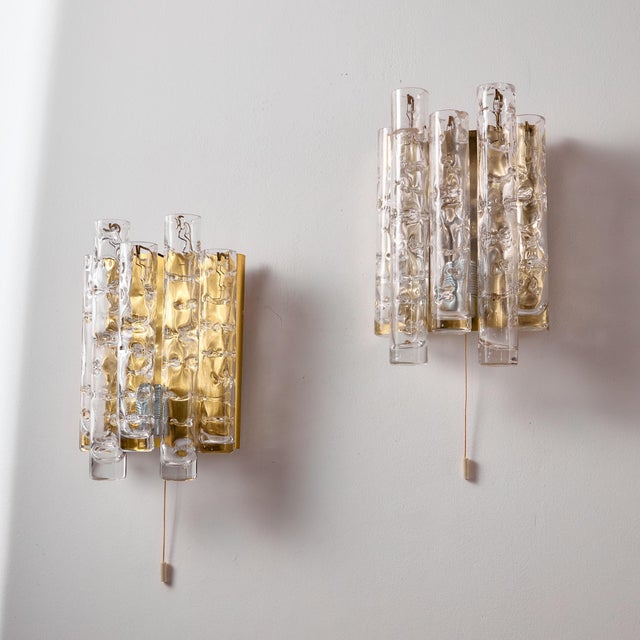 Glass and brass wall lamp from the 1960s by Doria Leuchten. Thanks to its glass lampshades, it gives off a cosy glow,...