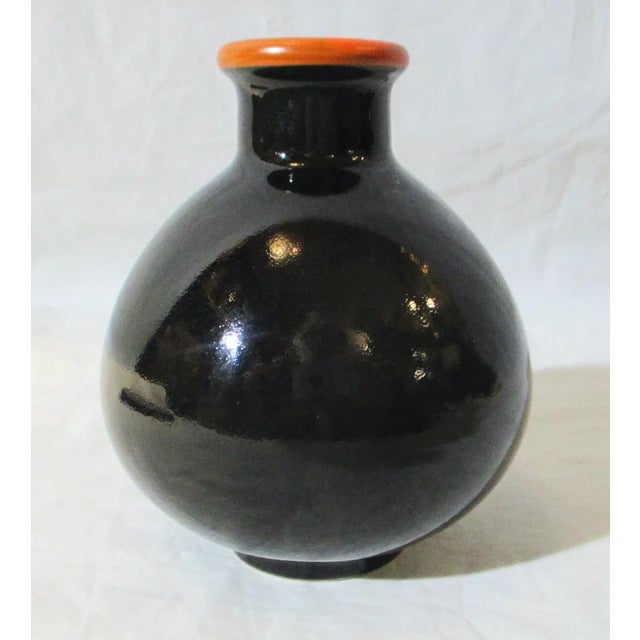 Arts and Crafts small porcelain vase. Glossy black body with red trim. No markings. American-made, the size is 4" tall and...