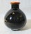 Arts and Crafts small porcelain vase. Glossy black body with red trim. No markings. American-made, the size is 4" tall and...