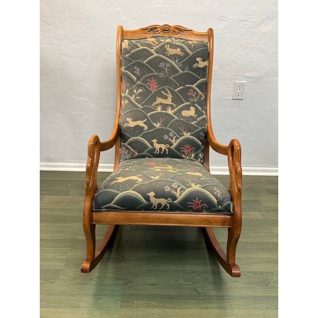 Charming vintage rocking chair crafted from solid wood, featuring graceful hand-carved details and a gently sculpted...