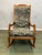 Charming vintage rocking chair crafted from solid wood, featuring graceful hand-carved details and a gently sculpted...