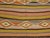 An intermediate size vintage Turkish Kilim with a colorful striped design throughout.