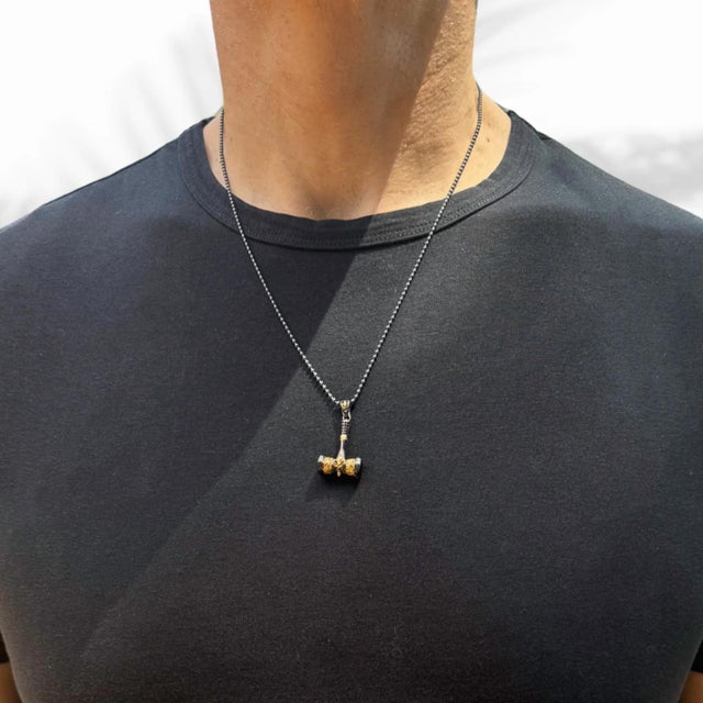 Discover the perfect blend of elegance and rugged charm with the Sterling Silver & Gold Hammer Pendant Necklace, a unique...