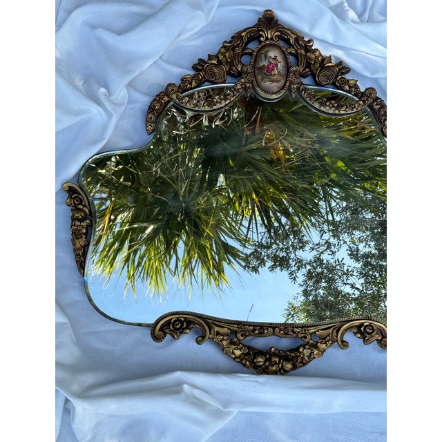 An exquisite antique ornate gilt wall mirror featuring beautifully sculpted Rococo-inspired scrollwork, floral detailing,...
