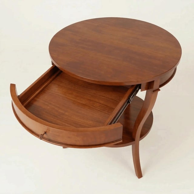 The Kensington Mahogany Bedside Table is built in solid mahogany after Regency-era round tables. A round top with a shaped...