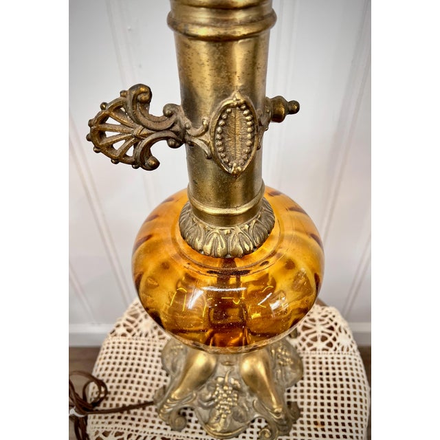 Elevate your décor with this exquisite vintage table lamp, crafted from solid brass and embodying the timeless glamour of...